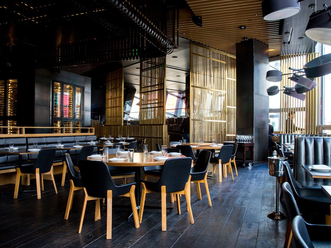 A busy restaurant dining room with people sharing a meal